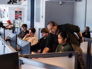Instructor Teaching Students using Classroom Computers