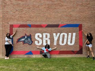 SB You picture of students pointing out the new branding