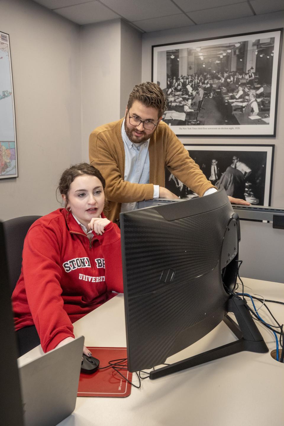 Instructor working with student at computer