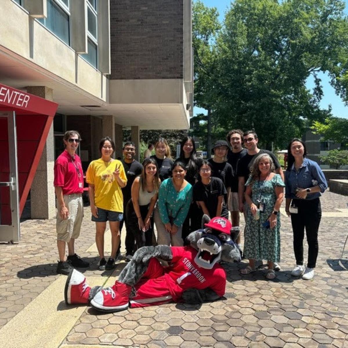 Image of student workers standing in front of the Tabler Center on Stony Brook University's campus